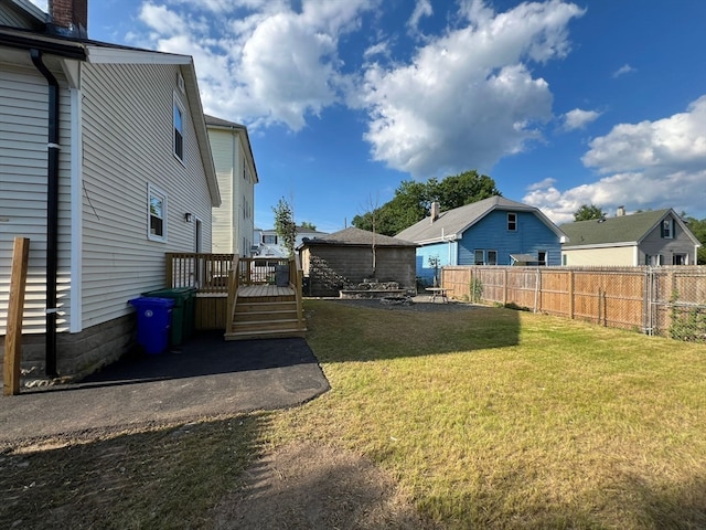 view of yard with a wooden deck and a patio area