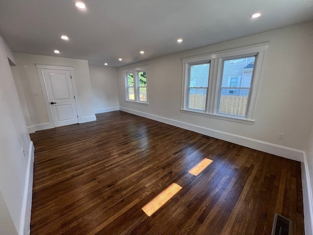 spare room with dark hardwood / wood-style flooring