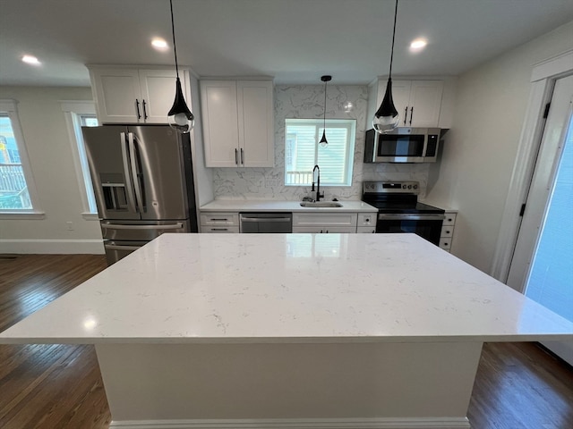 kitchen featuring sink, appliances with stainless steel finishes, dark hardwood / wood-style flooring, and plenty of natural light