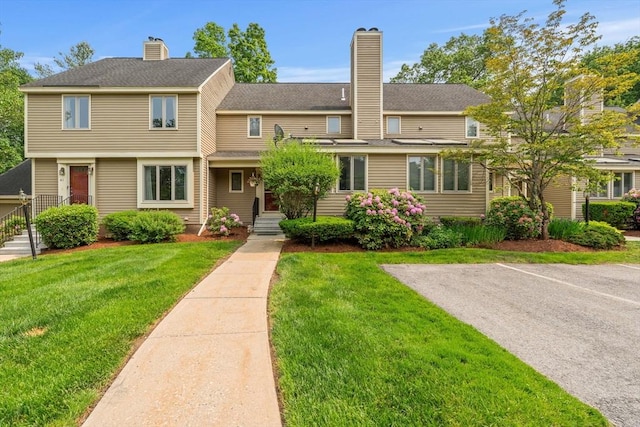 42 Brickett Hill Cir Unit 114, Haverhill, MA 01830 - view of front of home with a chimney and a front lawn