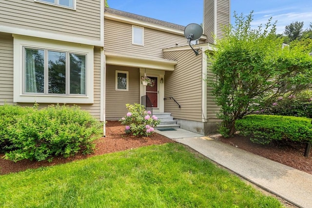 42 Brickett Hill Cir Unit 114, Haverhill, MA 01830 - doorway to property with a chimney and a lawn