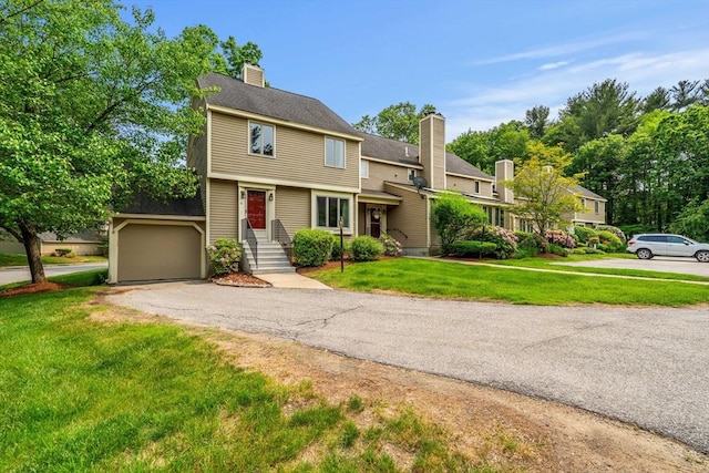 42 Brickett Hill Cir Unit 114, Haverhill, MA 01830 - view of front of house with a chimney, a front lawn, a garage, and driveway