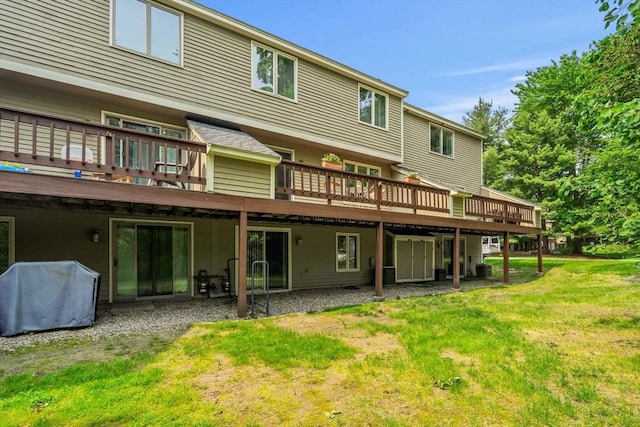 42 Brickett Hill Cir Unit 114, Haverhill, MA 01830 - back of property featuring a wooden deck and a lawn