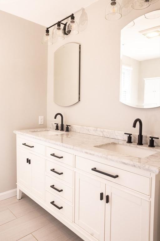 bathroom with double vanity and a sink