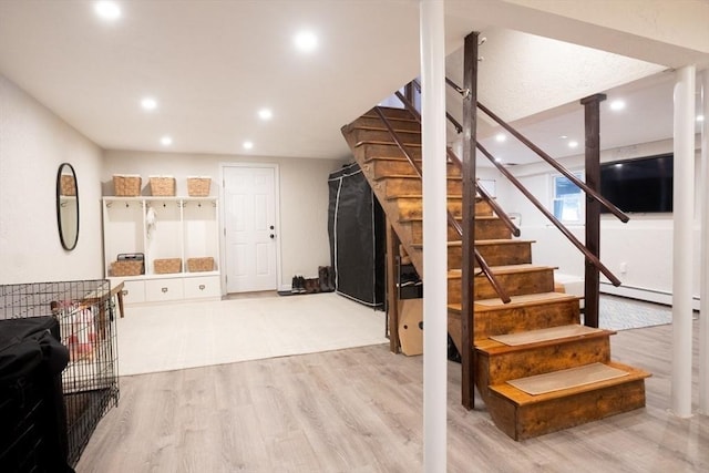 interior space with recessed lighting, stairs, and wood finished floors