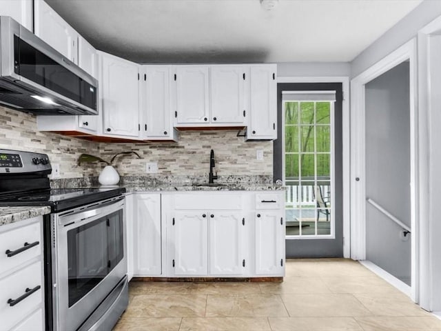 189 Brigham Hill Rd, Grafton, MA 01536 - kitchen featuring stainless steel appliances, decorative backsplash, white cabinets, a sink, and light stone counters