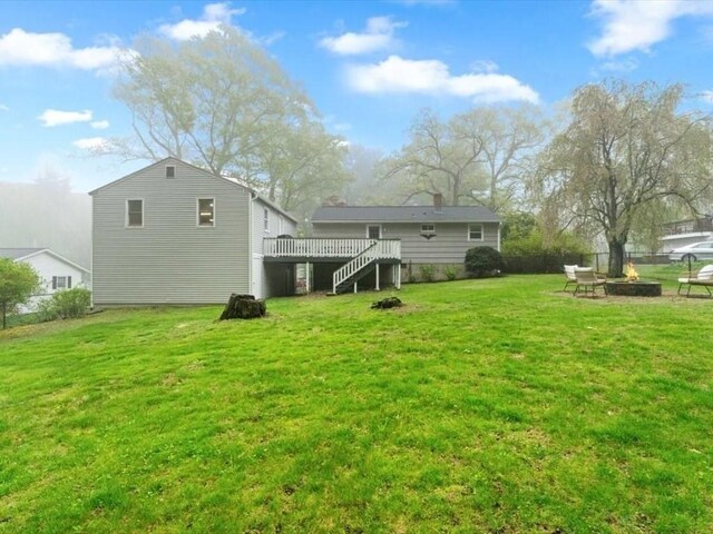 189 Brigham Hill Rd, Grafton, MA 01536 - rear view of property with an outdoor fire pit, stairway, a wooden deck, and a yard