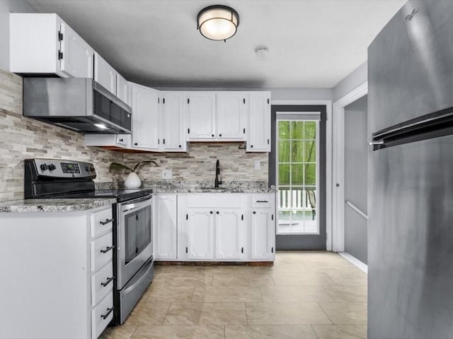 189 Brigham Hill Rd, Grafton, MA 01536 - kitchen featuring appliances with stainless steel finishes, a sink, backsplash, white cabinetry, and light stone counters