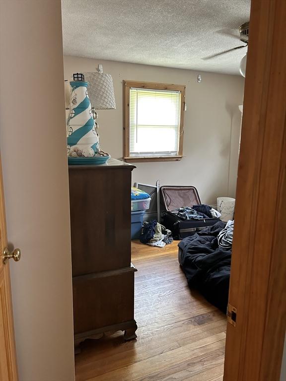 554 Main St, Becket, MA 01223 - bedroom featuring a textured ceiling, wood finished floors, and a ceiling fan