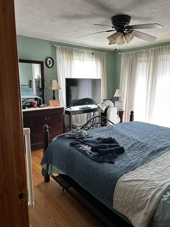 554 Main St, Becket, MA 01223 - bedroom with wood finished floors, a textured ceiling, and ceiling fan