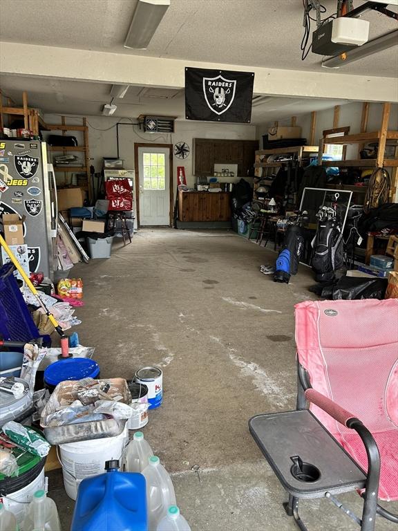 554 Main St, Becket, MA 01223 - garage with a garage door opener and fridge