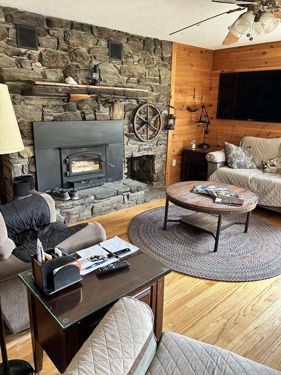 554 Main St, Becket, MA 01223 - living room with a fireplace, ceiling fan, and wood finished floors