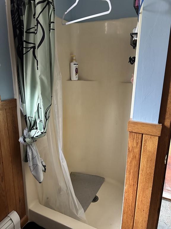 554 Main St, Becket, MA 01223 - full bath with a shower with curtain and baseboard heating