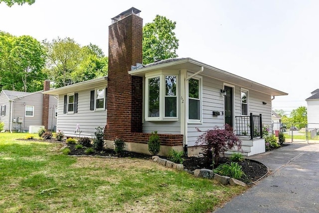 62 Forest St, Middleboro, MA 02346 - view of front facade with a front lawn and a chimney