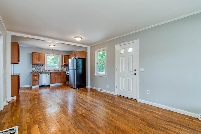 62 Forest St, Middleboro, MA 02346 - kitchen featuring freestanding refrigerator, dishwasher, brown cabinets, dark wood-style flooring, and baseboards
