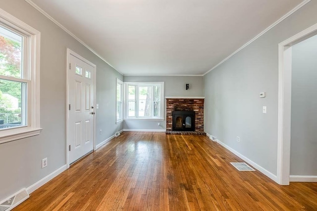 62 Forest St, Middleboro, MA 02346 - unfurnished living room featuring hardwood / wood-style floors, baseboards, crown molding, and a fireplace