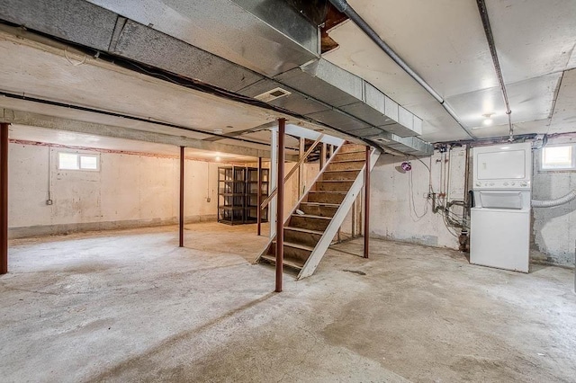 62 Forest St, Middleboro, MA 02346 - basement featuring stacked washer and clothes dryer and stairs