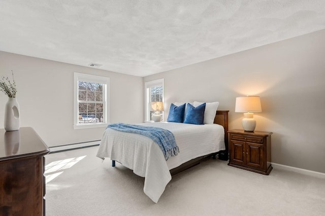 bedroom with baseboards, light colored carpet, visible vents, and baseboard heating