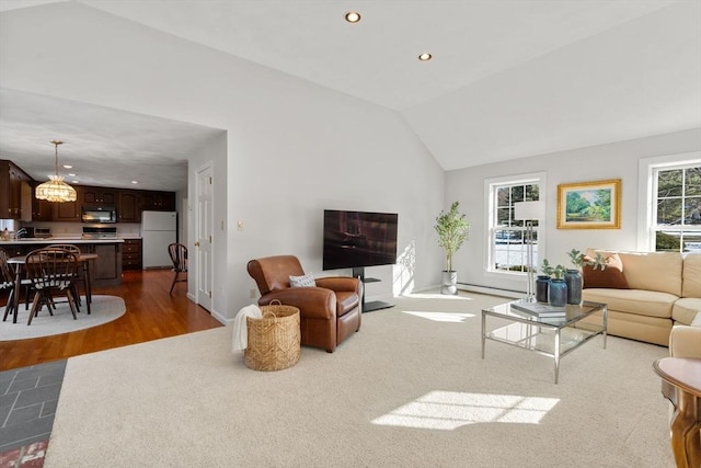 living area featuring lofted ceiling, baseboards, wood finished floors, and recessed lighting