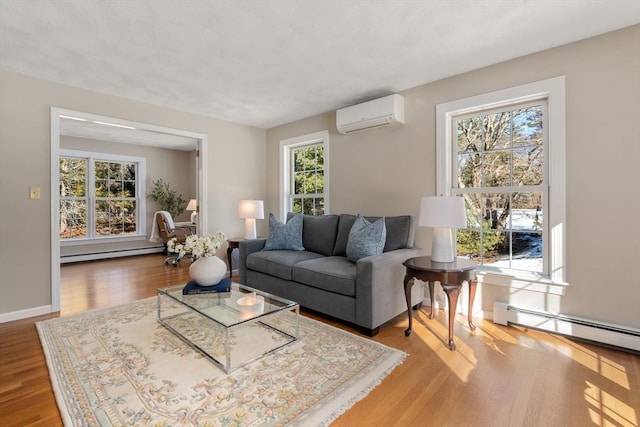 living area featuring baseboard heating, a baseboard heating unit, wood finished floors, a wall mounted air conditioner, and baseboards