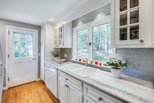 1441 Old Post Rd, Barnstable, MA 02648 - kitchen with white dishwasher, tasteful backsplash, healthy amount of natural light, white cabinets, and recessed lighting