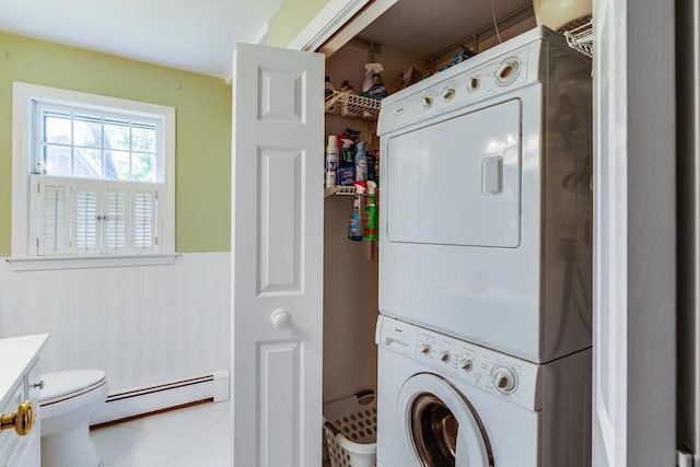 1441 Old Post Rd, Barnstable, MA 02648 - washroom featuring a baseboard radiator and estacked washer and dryer