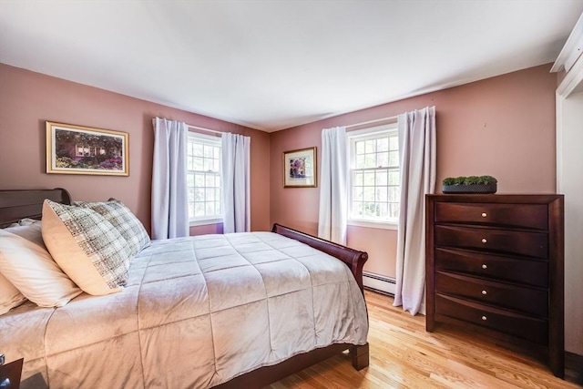 1441 Old Post Rd, Barnstable, MA 02648 - bedroom with a baseboard radiator, multiple windows, and light wood-style floors