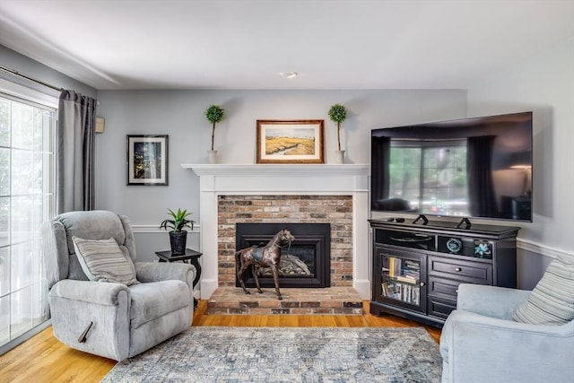 1441 Old Post Rd, Barnstable, MA 02648 - living area featuring wood finished floors and a brick fireplace