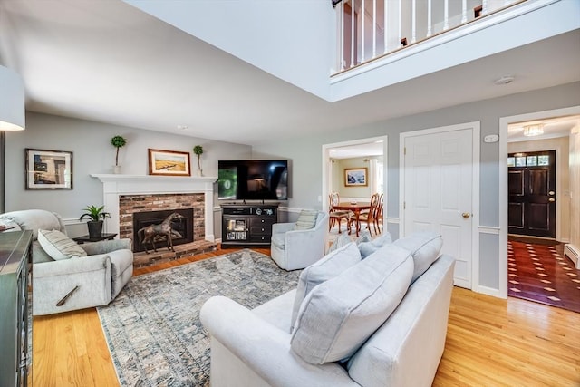1441 Old Post Rd, Barnstable, MA 02648 - living room featuring light wood-type flooring and a fireplace