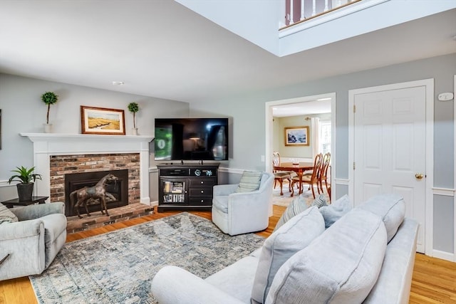 1441 Old Post Rd, Barnstable, MA 02648 - living area with wood finished floors and a brick fireplace