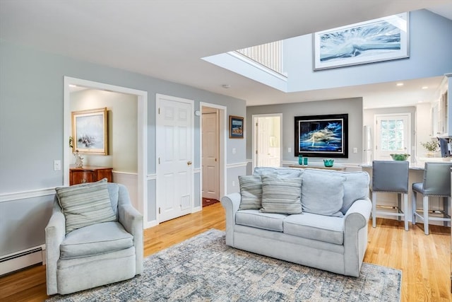 1441 Old Post Rd, Barnstable, MA 02648 - living area with a skylight, light wood-style flooring, and baseboard heating