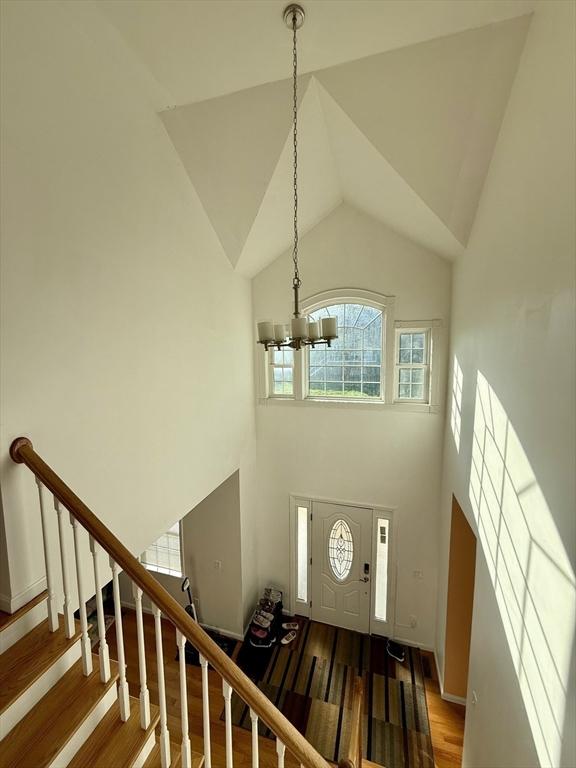 99 Dudley Rd, Oxford, MA 01540 - foyer with a chandelier, a towering ceiling, wood finished floors, and stairway