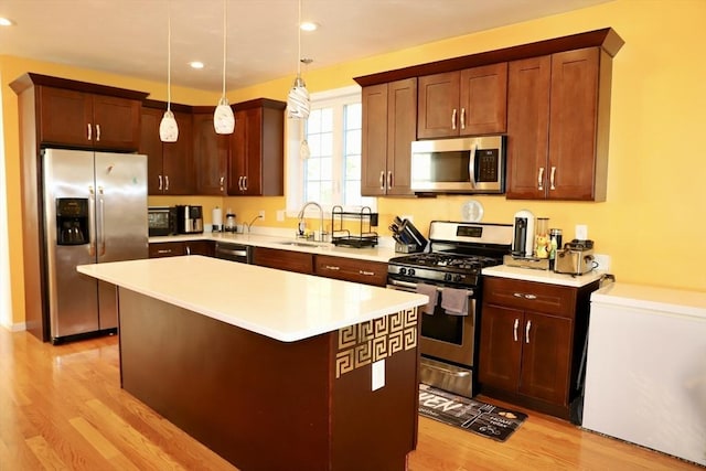 99 Dudley Rd, Oxford, MA 01540 - kitchen with appliances with stainless steel finishes, a sink, a kitchen island, light wood finished floors, and recessed lighting