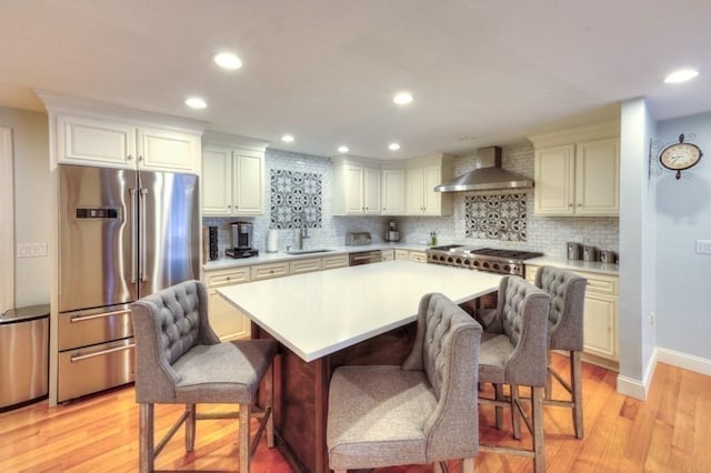 15 Bailin Dr, Worcester, MA 01604 - kitchen featuring wall chimney exhaust hood, stainless steel appliances, light countertops, a sink, and recessed lighting