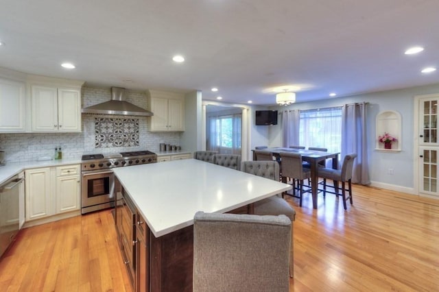 15 Bailin Dr, Worcester, MA 01604 - kitchen featuring wall chimney exhaust hood, high end stainless steel range oven, light countertops, light wood-type flooring, and recessed lighting