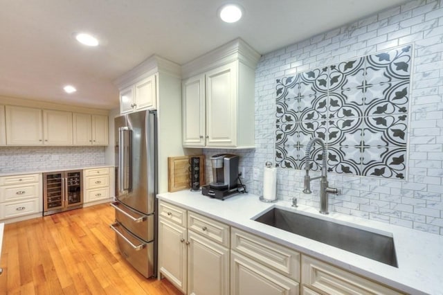 15 Bailin Dr, Worcester, MA 01604 - kitchen featuring freestanding refrigerator, wine cooler, backsplash, a sink, and white cabinets