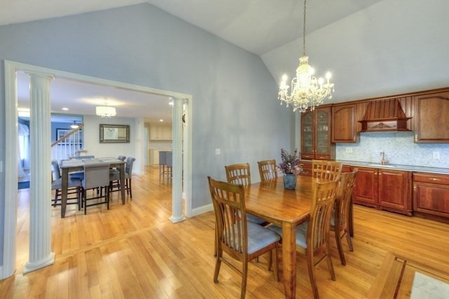 15 Bailin Dr, Worcester, MA 01604 - dining area featuring ornate columns, a chandelier, high vaulted ceiling, and light wood finished floors