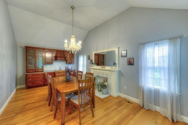 15 Bailin Dr, Worcester, MA 01604 - dining space with a chandelier, high vaulted ceiling, light wood-style floors, and baseboards