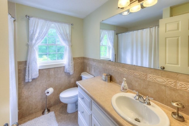 15 Bailin Dr, Worcester, MA 01604 - bathroom featuring tile walls, tile patterned floors, toilet, vanity, and a wainscoted wall
