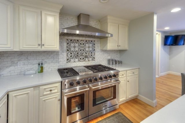 15 Bailin Dr, Worcester, MA 01604 - kitchen with range with two ovens, wall chimney exhaust hood, light countertops, baseboards, and light wood finished floors