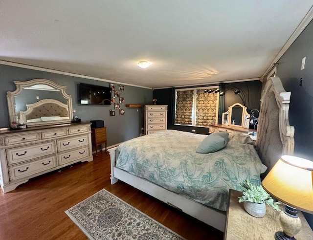 bedroom featuring ornamental molding and wood finished floors