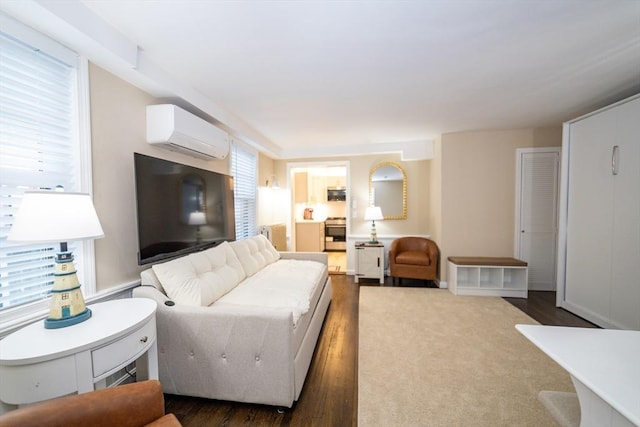 living room featuring dark wood-type flooring and a wall unit AC