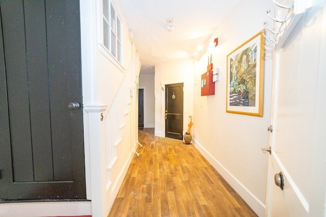 corridor with light hardwood / wood-style floors