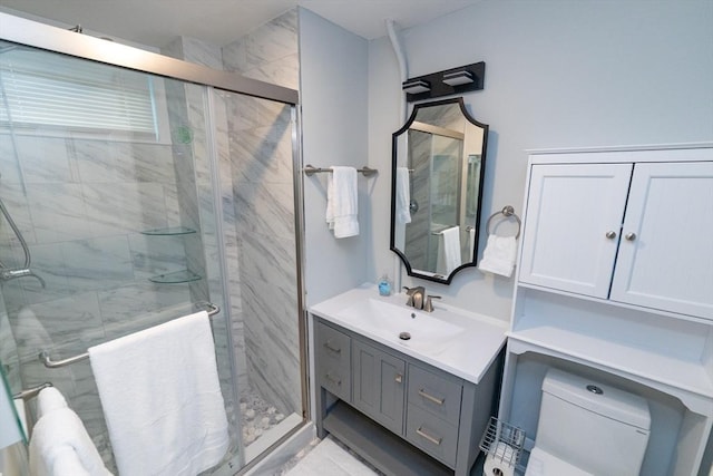 bathroom featuring toilet, an enclosed shower, and vanity