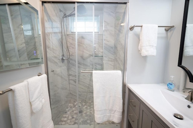 bathroom with vanity and a shower with door