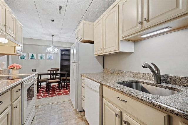 10 Foster St Unit 203, Wakefield, MA 01880 - kitchen with pendant lighting, cream cabinets, a sink, and white appliances