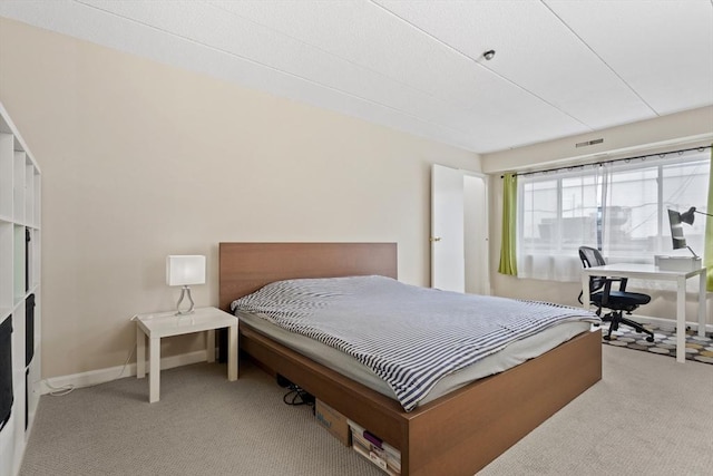 10 Foster St Unit 203, Wakefield, MA 01880 - bedroom with light carpet, baseboards, and visible vents