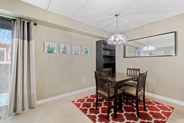 10 Foster St Unit 203, Wakefield, MA 01880 - carpeted dining space with baseboards and a notable chandelier