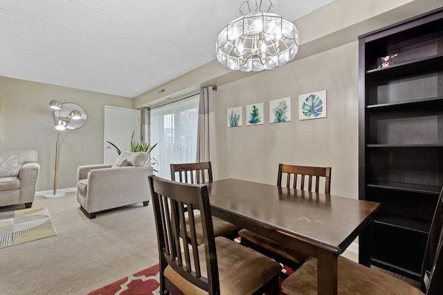 10 Foster St Unit 203, Wakefield, MA 01880 - dining area featuring an inviting chandelier, carpet, and baseboards