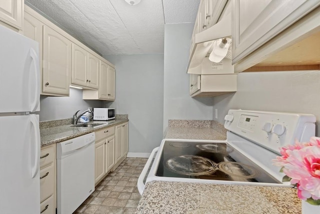10 Foster St Unit 203, Wakefield, MA 01880 - kitchen with a sink, white appliances, a textured ceiling, light floors, and light countertops